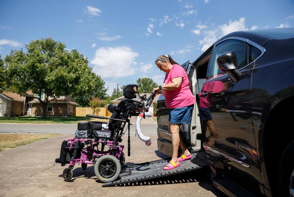 Laurie Sharp demonstrates the wheelchair ramp on her converted Chrysler Pacifica on Sep. 9, 2023. The van was converted for wheelchair access, a process which took several weeks and cost $30,000.