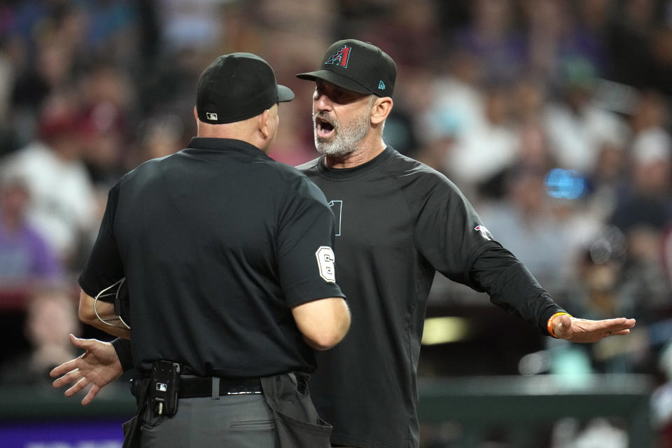 Arizona Diamondbacks manager Torey Lovullo, right, argues with umpire Mark Carlson, left, after Lovullo and Diamondbacks' Joc Pederson was ejected during the eighth inning of a baseball game against the Cincinnati Reds Monday, May 13, 2024, in Phoenix. The Diamondbacks won 6-5. (AP Photo/Ross D. Franklin)