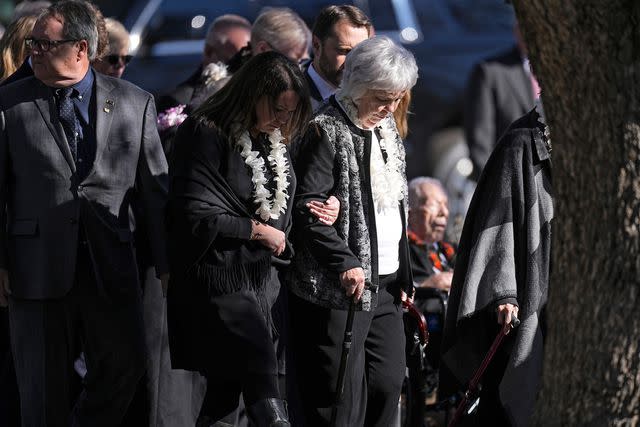 <p>John Bazemore/AP Photo</p> Family members wearing leis at Rosalynn Carter's private funeral service in Plains