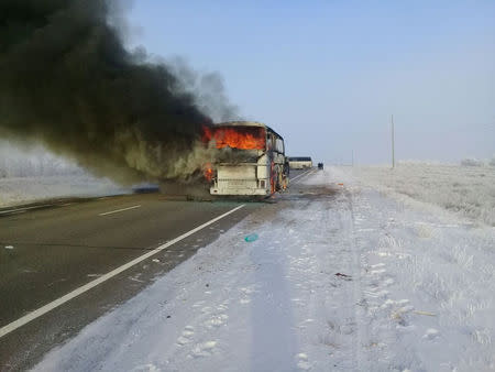 A view shows a burning bus on a route used by migrant workers heading to Russia, in the Aktobe region, Kazakhstan January 18, 2018. The Committee for Emergency Situations of the Ministry of Internal Affairs of the Republic of Kazakhstan/Handout via REUTERS