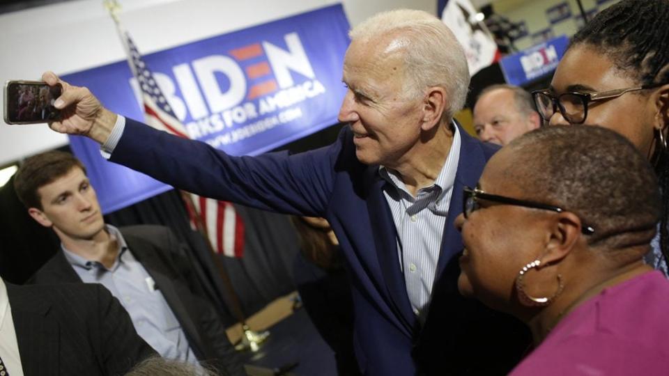 Former vice president and 2020 Democratic presidential candidate Joe Biden takes a selfie attendees during a campaign event on June 11, 2019 in Davenport, Iowa. (Photo by Joshua Lott/Getty Images)