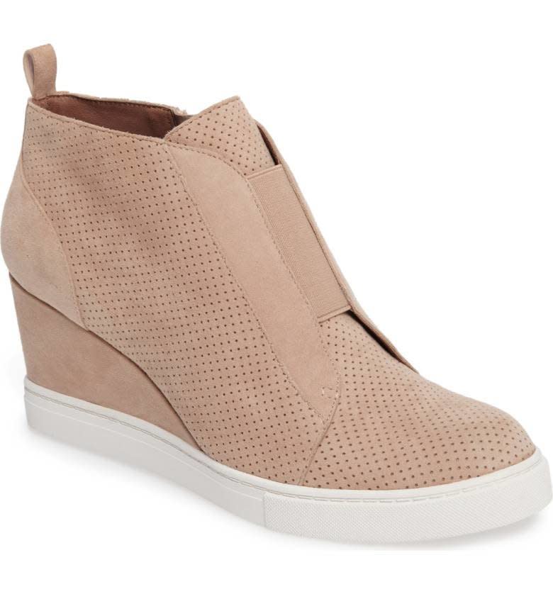 Similar to flats, there is no rule that states sneakers can't be worn with midi skirts. We want comfort sometimes, so these classic street shoes offer the perfect amount of height and casualness. Shop them <strong><a href="http://shop.nordstrom.com/s/linea-paolo-felicia-wedge-bootie-women/4413353?origin=category-personalizedsort&amp;fashioncolor=BLACK%20PERF%20NAPPA" target="_blank">here</a></strong>.