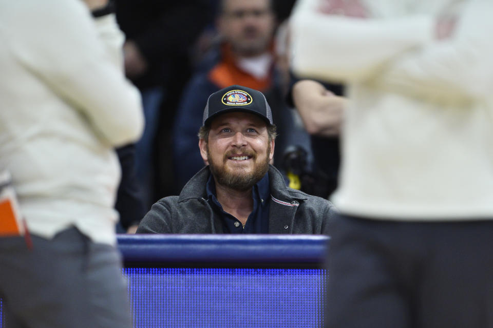 Actor Cole Hauser sits courtside during the first half of an NCAA college basketball game between Syracuse and Notre Dame in Syracuse, N.Y., Saturday, Jan. 14, 2023. (AP Photo/Adrian Kraus)