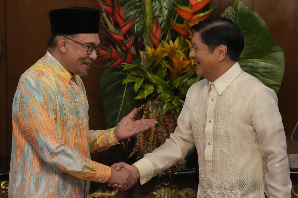 Philippine President Ferdinand Marcos Jr., right, shakes hands with Malaysia's Prime Minister Anwar Ibrahim after delivering their statements to the press at the Malacanang presidential palace in Manila, Philippines on Wednesday Mar. 1, 2023. (AP Photo/Aaron Favila, Pool)