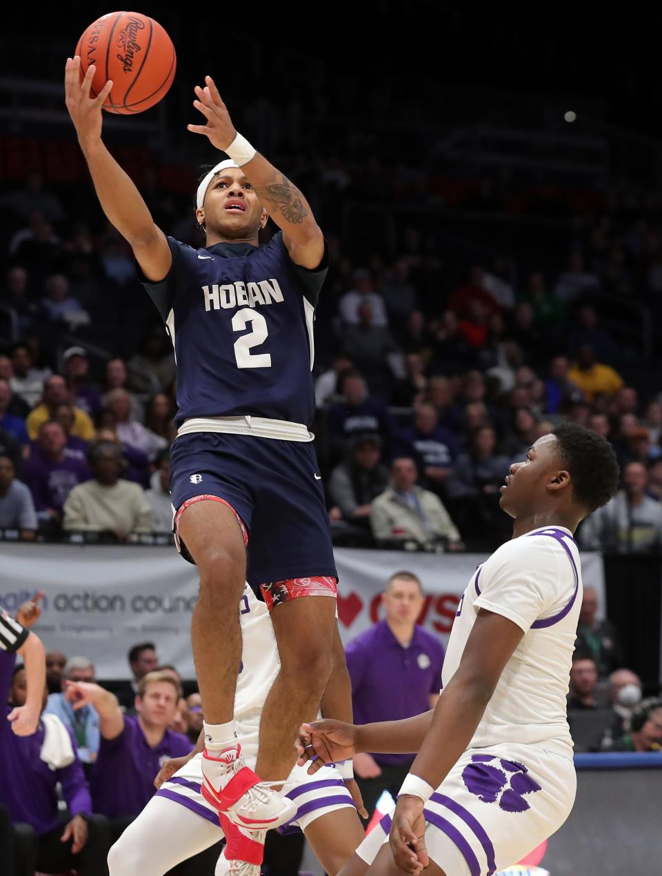 Hoban guard Will Scott Jr., left, shoots over Pickerington Central guard Juwan Turner during the first half of the OHSAA Division I state final, Sunday, March 19, 2023, in Dayton.