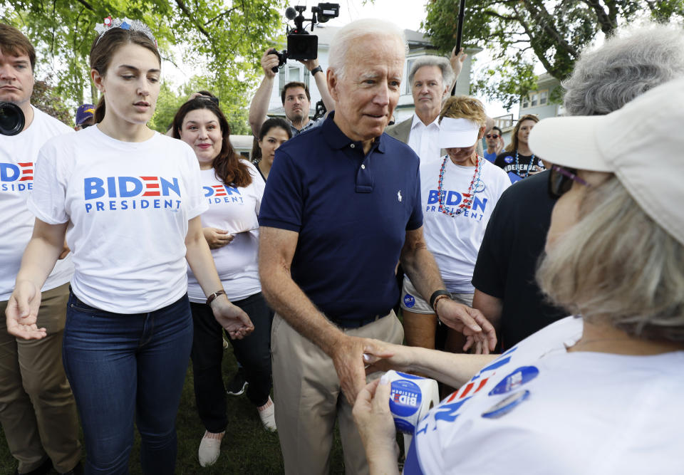 Former vice president and Democratic presidential candidate Joe Biden greets supporters before walking in the Independence Fourth of July parade, Thursday, July 4, 2019, in Independence, Iowa. (AP Photo/Charlie Neibergall)