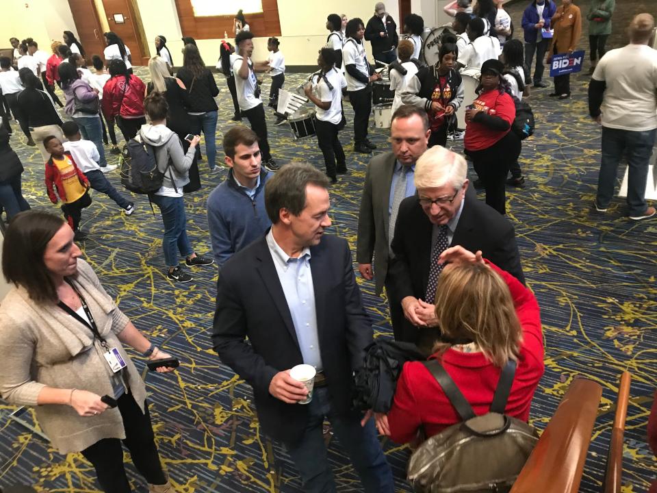 Montana Gov. Steve Bullock and Iowa Attorney General Tom Miller speak with a voter ahead of the Iowa Democratic Party's Liberty and Justice Celebration.