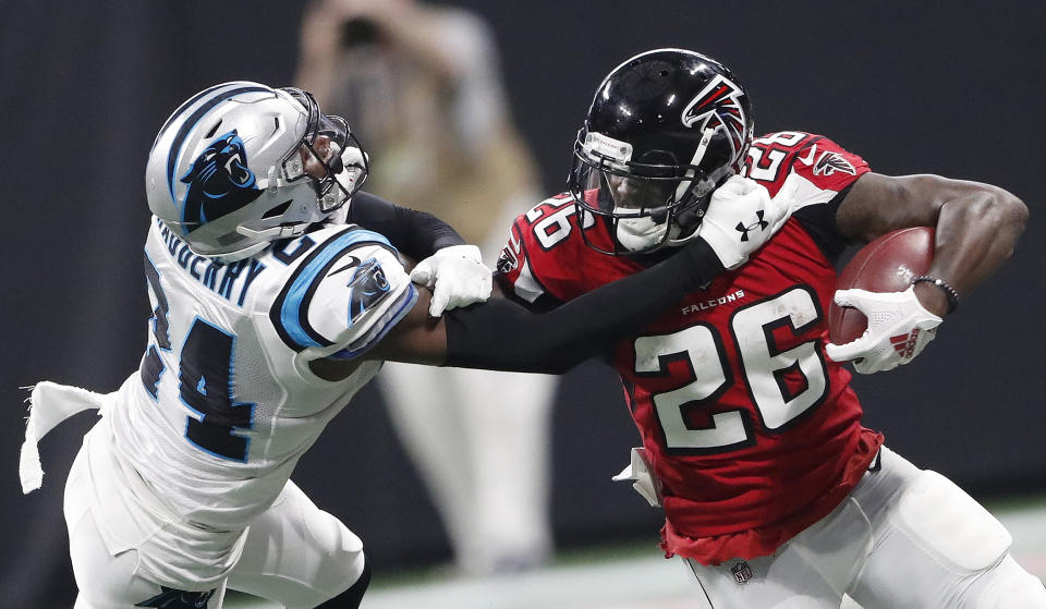 Atlanta Falcons running back Tevin Coleman (26) runs against Carolina Panthers cornerback James Bradberry (24) during the second half of an NFL football game, Sunday, Sept. 16, 2018, in Atlanta. (AP Photo/John Bazemore)