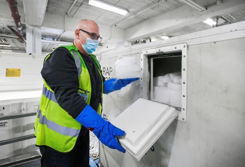 A KLM Cargo worker puts dry ice in a cool box at Amsterdam's Schiphol Airport