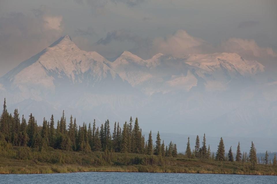 Tall peaks in the Alaska Range tower over Wonder Lake near Kantishna in Denali National Park.