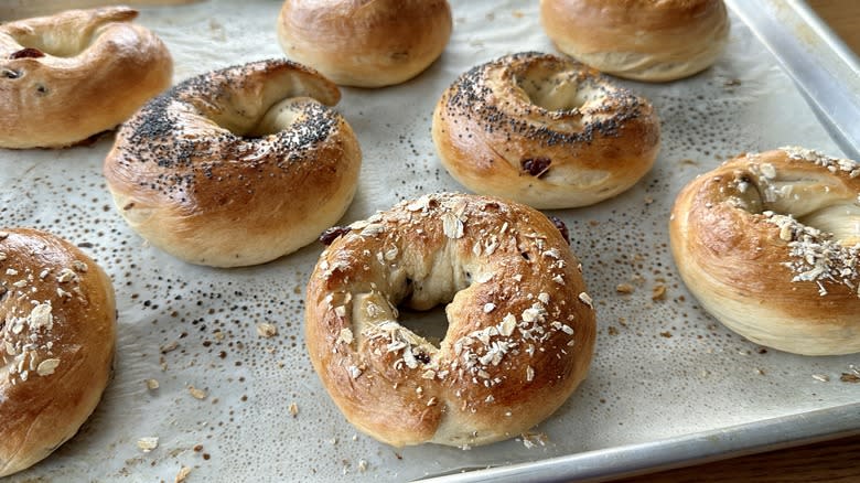 garnished bagels on baking sheet