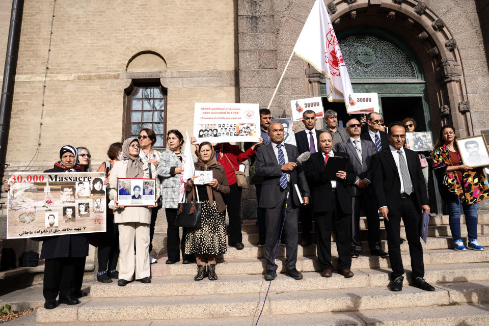 Supporters of the People's Mojahedin Organization of Iran protest outside Stockholm's district court on the first day of the trial of Hamid Noury, in Stockholm, Tuesday, Aug. 10, 2021. An Iranian man is standing trial in Sweden charged with grave war crimes and murder during the final phase of the Iran-Iraq war in the 1980s. The trial of Hamid Nouri comes just days after Iran's hard-line President Ebrahim Raisi took office as the highest-ranking civilian leader in the Islamic Republic. (Stefan Jerrevang/TT News Agency via AP)