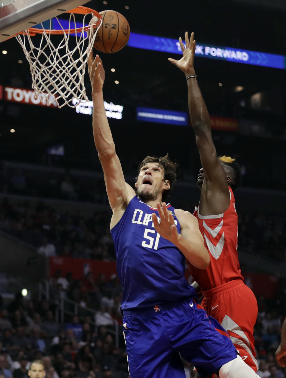 Los Angeles Clippers' Boban Marjanovic (51) drives past Houston Rockets' Clint Capela during the first half of an NBA basketball game Sunday, Oct. 21, 2018, in Los Angeles. (AP Photo/Marcio Jose Sanchez)