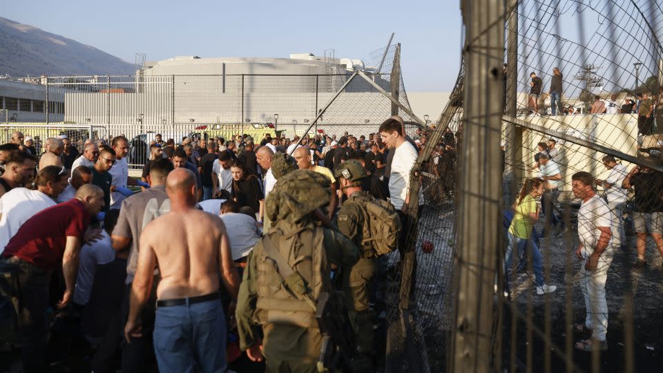 Israeli security forces and local residents gather at a site of the rocket attack in the Golan Heights area on July 27, 2024. - Jalaa Marey/AFP/Getty Images