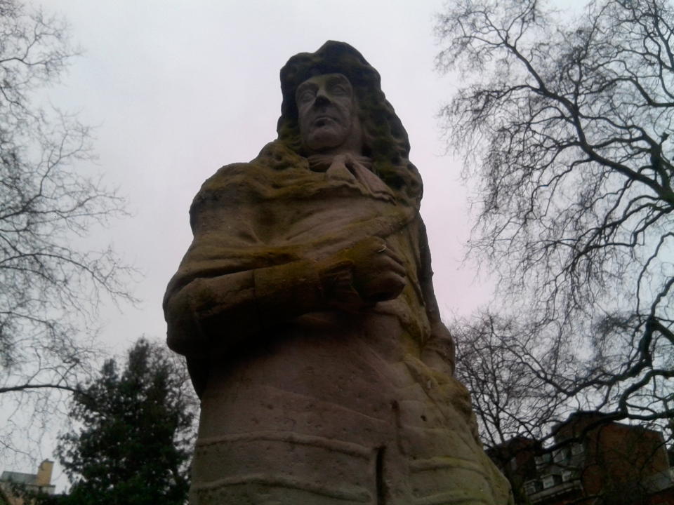 Photo of a statue in front of some trees