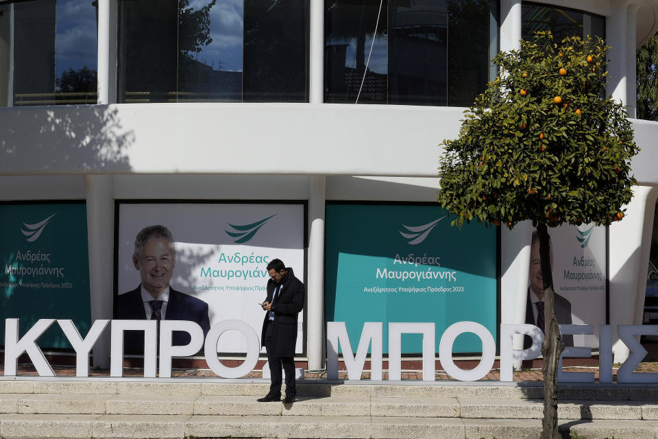 A man stands outside the campaign headquarters of presidential candidate Andreas Mavroyiannis, with the words in Greek read: "Cyprus Can". in capital Nicosia, Cyprus, Wednesday, Feb. 8, 2023. A youthful former foreign minister who campaigned as a unifier unconstrained by antiquated ideological and party lines will take on a veteran diplomat with broad voter appeal in a Feb. 12 runoff for the presidency of ethnically divided Cyprus. Cyprus' former top diplomat Nikos Christodoulides, 49, came out on top with 32% of the vote in the Feb. 5 first round. Andreas Mavroyiannis, 66, clinched second place with a surprisingly strong showing of 29.6% of votes. (AP Photo/Petros Karadjias)