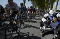 FILE - French gendarmes and members of the organization remove climate activists who blocked the road as riders pass during the fifteenth stage of the Tour de France cycling race over 202.5 kilometers (125.5 miles) with start in Rodez and finish in Carcassonne, France, Sunday, July 17, 2022. (AP Photo/Thibault Camus, File)