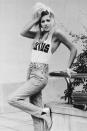 <p>Mandy Smith in a tank top, high-waisted jeans, and boots. </p>