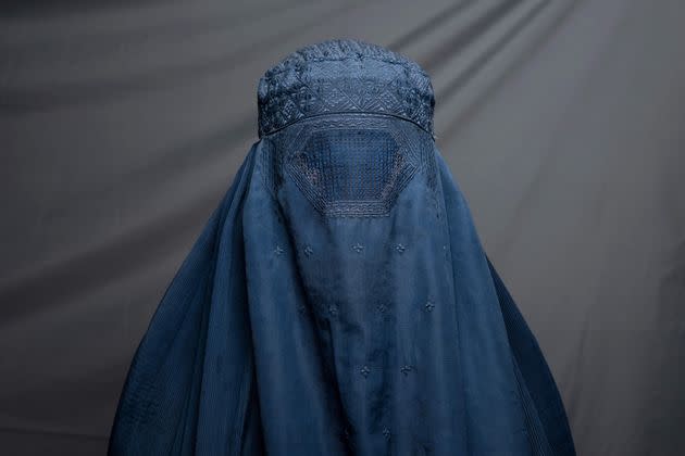 In this picture taken on July 30, 2022, shampoo factory worker Robina, 40, poses for a portrait in Kandahar. - Since their takeover a year ago, the Taliban have squeezed Afghan women out of public life, imposing suffocating restrictions on where they can work, how they can travel, and what they can wear. There is hardly a woman in the country who has not lost a male relative in successive wars, while many of their husbands, fathers, sons and brothers have also lost their jobs or seen their income shattered as a result of a deepening economic crisis. (Photo: Photo by LILLIAN SUWANRUMPHA/AFP via Getty Images)