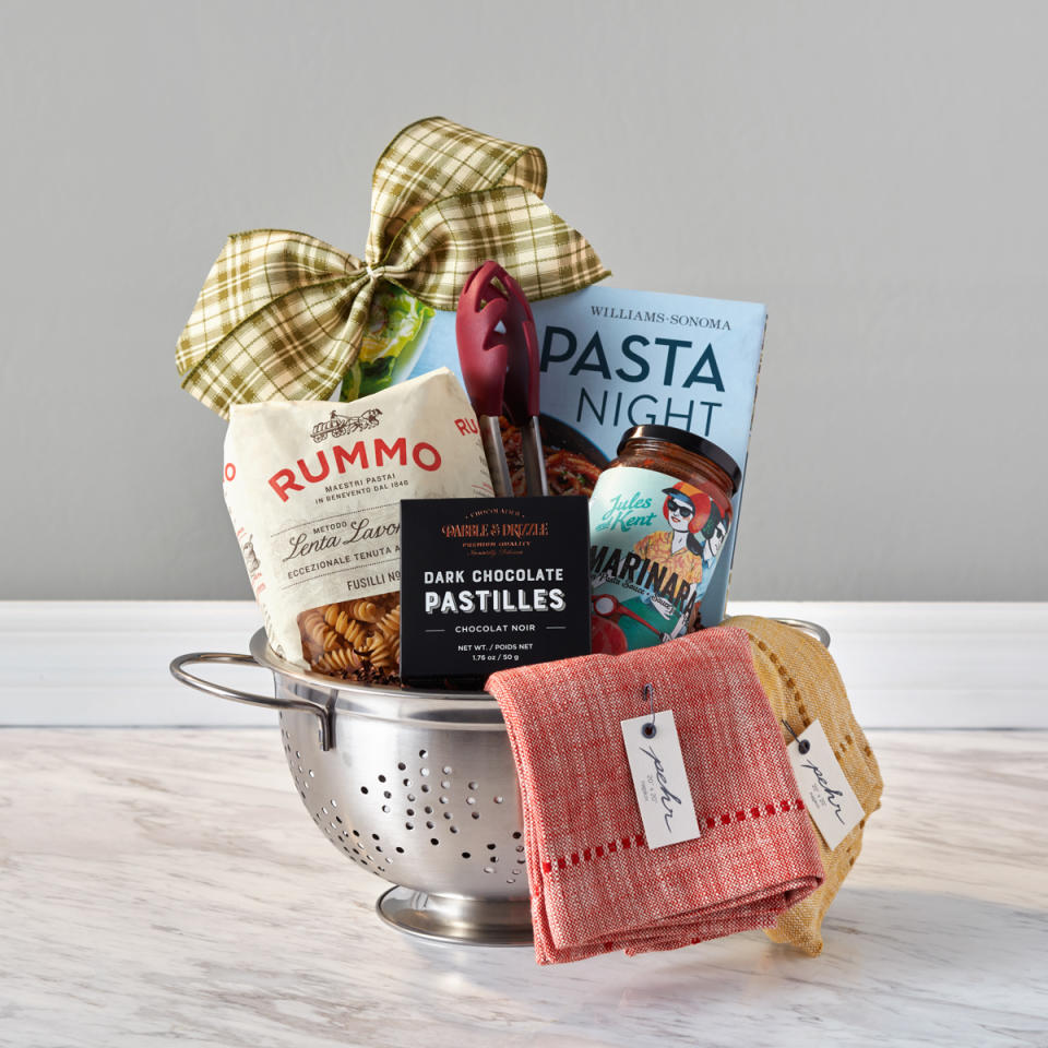 <p>For the pasta lover, snap up this selection that includes a William Sonoma <em>Pasta Night</em> cookbook, authentic pasta sauce from Jules and Kent (Vancouver), silicone pasta tongs, RUMMO gourmet fusilli pasta noodles, Pehr Design napkins (Toronto), dark chocolate from fellow Canadian Dabble & Drizzle, and a stainless steel colander. <br><a rel="nofollow noopener" href="https://www.baskits.com/pasta-night-g71518" target="_blank" data-ylk="slk:SHOP IT: Baskits, $75;elm:context_link;itc:0;sec:content-canvas" class="link "><strong>SHOP IT: Baskits, $75</strong></a> </p>