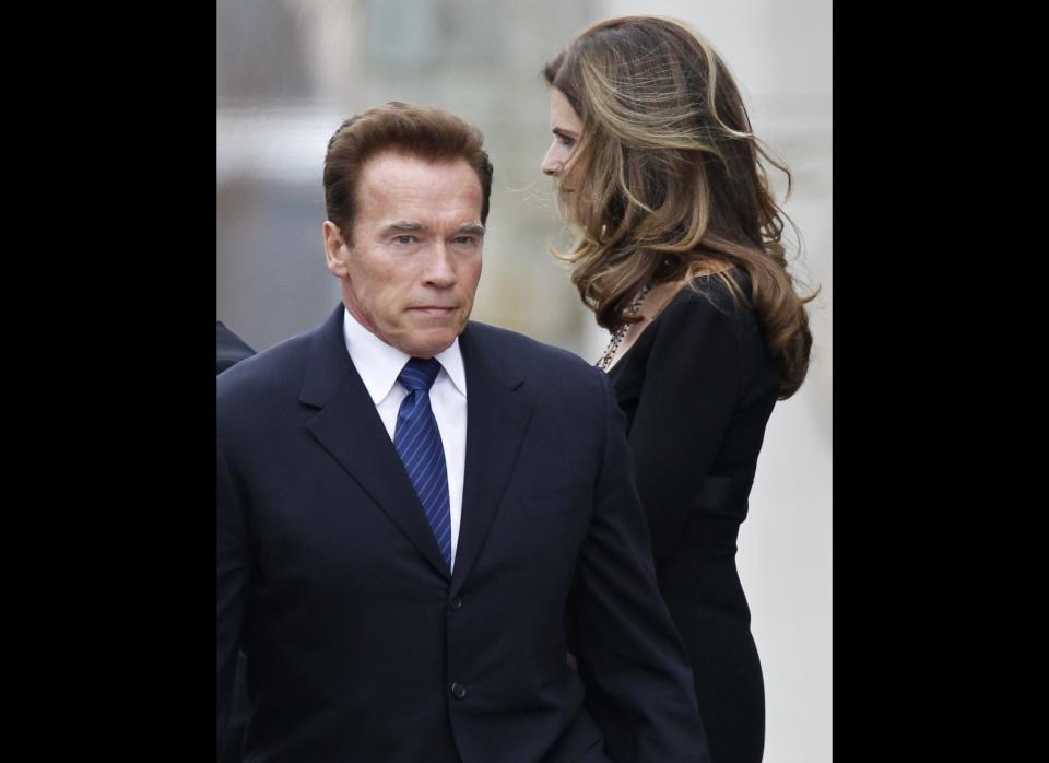 Maria Shriver, right, and her husband, actor and former California Governor Arnold Schwarzenegger, stand amid family members and other mourners as they leave the funeral Mass for her father, R. Sargent Shriver, at Our Lady of Mercy Catholic church in Potomac, Md., just outside Washington, Saturday, Jan. 22, 2011. Shriver, the man responsible for launching the Peace Corps after marrying into the Kennedy family, died last Tuesday at age 95 after suffering from Alzheimer's disease for years. (AP Photo/J. Scott Applewhite)