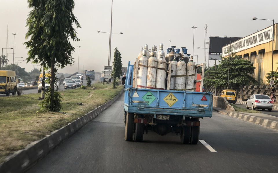 A truck transports bottles of oxygen along a street in Lagos, Nigeria Saturday, Feb. 6, 2021. A crisis over the supply of medical oxygen for coronavirus patients has struck in Africa and Latin America, where warnings went unheeded at the start of the pandemic and doctors say the shortage has led to unnecessary deaths. Doctors in Nigeria anxiously monitor traffic as oxygen deliveries move through gridlocked streets of Lagos. (AP Photo/Lekan Oyekanmi)