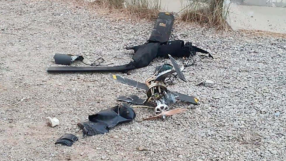 Parts of the wreckage of a drone lie on the ground at Baghdad airport.