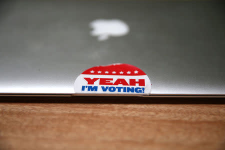 A sticker is seen on the computer of Rock the Vote Digital Director Sara Tabatabaie, 26, in Los Angeles, California, U.S., November 4, 2016. REUTERS/Lucy Nicholson