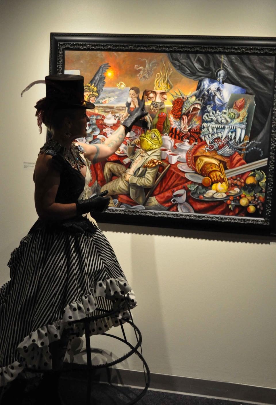 Artist Carrie Ann Baade with "Allegory of Bad Government," part of her latest solo exhibition, "The Surreal Imagining," at TCC Fine Art Gallery running through Dec. 7, 2023.