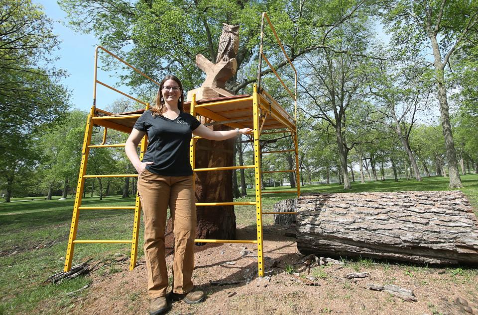 Gabriele Edwards, the Ames city forester, stands near a black walnut tree in Brookside Park on Thursday, May 11, 2023. The tree needed to be taken down, but Edwards championed retaining the trunk for the carving.