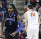 Memphis forward Shaq Goodwin (2) celebrates a basket against Virginia during the first half of an NCAA college basketball third-round tournament game, Sunday, March 23, 2014, in Raleigh. (AP Photo/Gerry Broome)