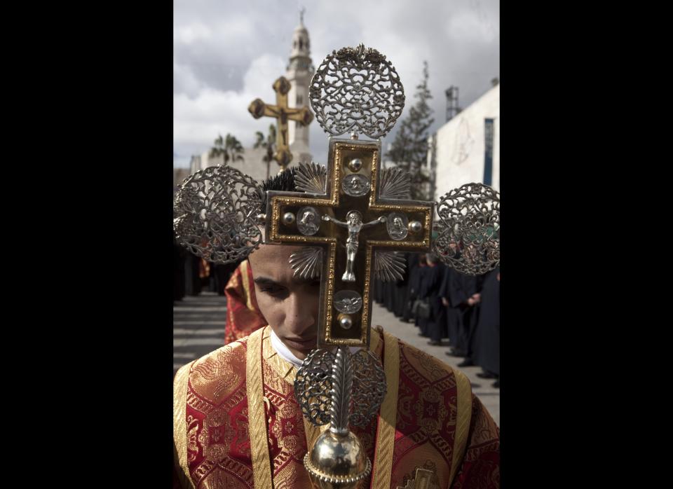 Greek Orthodox priests take part in a Christmas procession at Manger Square outside the Church of the Nativity, the traditional birthplace of Jesus Christ, in the West Bank city of Bethlehem on January 6, 2011.