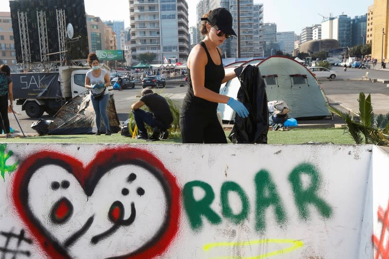 People clean the streets during ongoing anti-government protests in downtown Beirut,