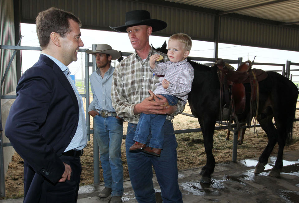 Russian Prime Minister Dmitry Medvedev, left, speaks with farmers as he visits cattle breeding farm Kotlyakovo in Bryansk region, 380 km (238 miles) southwest of Moscow, Russia, Wednesday, May 23, 2012. (AP Photo/RIA-Novosti, Yekaterina Shtukina, Presidential Press Service).