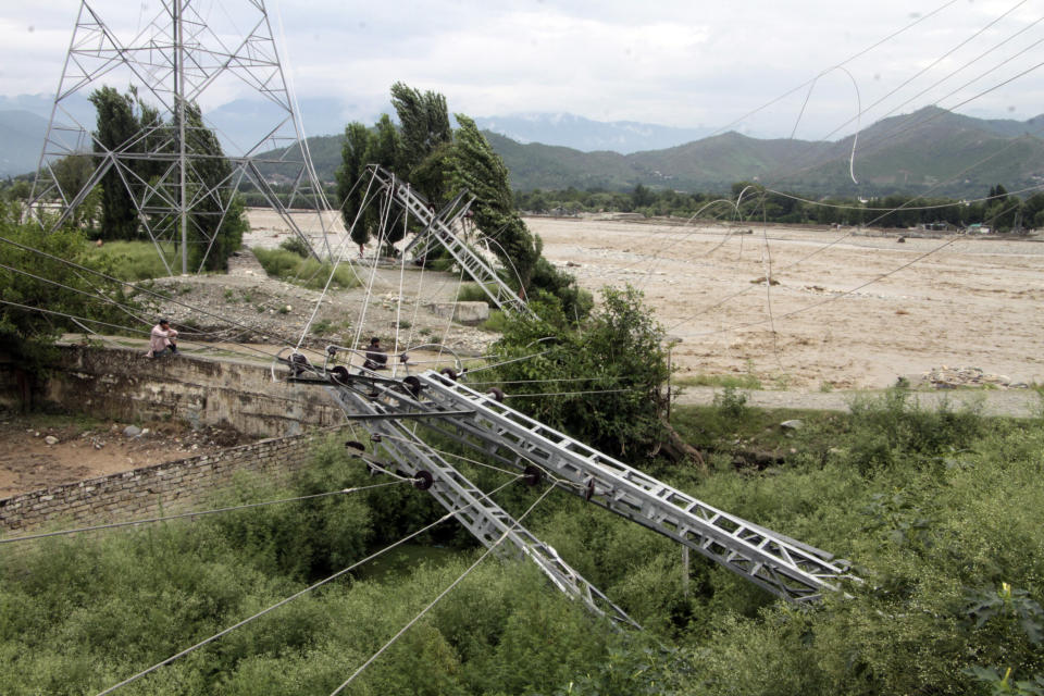 Damaged electrical towers on the ground after being damaged during the floods in Mingora, the capital of Swat valley in Pakistan, Saturday, Aug. 27, 2022. Officials say flash floods triggered by heavy monsoon rains across much of Pakistan have killed nearly 1,000 people and displaced thousands more since mid-June. (AP Photo/Naveed Ali)