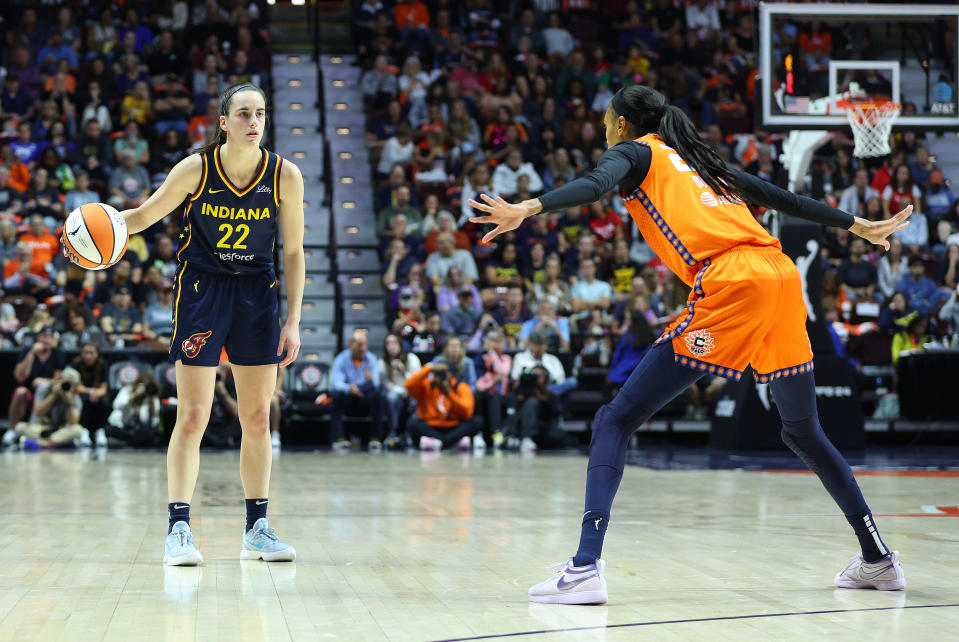 UNCASVILLE, CT - SEPTEMBER 22: Indiana Fever guard Caitlin Clark (22) and Connecticut Sun forward DeWanna Bonner (24) in action during the First Round and game 1 of the 2024 WNBA playoffs between Indiana Fever and Connecticut Sun on September 22, 2024, at Mohegan Sun Arena in Uncasville, CT. (Photo by M. Anthony Nesmith/Icon Sportswire via Getty Images)