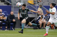 Los Angeles Galaxy defender Jorge Villafana, left, heads the ball as Austin FC forward Cecilio Dominguez chases him during the first half of a Major League Soccer match Saturday, May 15, 2021, in Carson, Calif. (AP Photo/Mark J. Terrill)