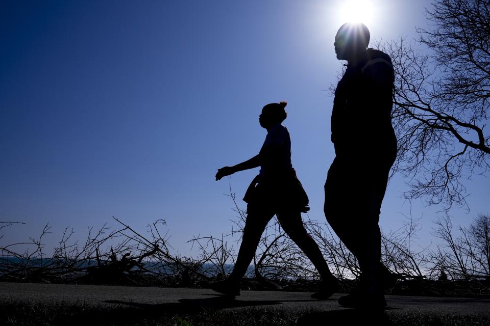 A couple enjoy unseasonably warm weather along the shores of Lake Michigan Tuesday, Feb. 27, 2024, in Milwaukee. (AP Photo/Morry Gash)