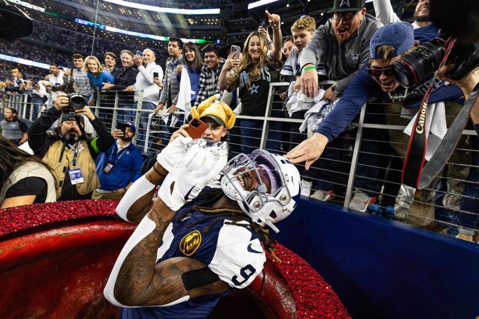 Dallas Cowboys cornerback KaVontae Turpin (9) pulls out a turkey legs from the Salvation Army kettles after scoring a touchdown in the fourth quarter of the Thanksgiving NFL game against the Washington Commanders at AT&T Stadium in Arlington on Thursday, Nov. 23, 2023. The Cowboys won 45-10.