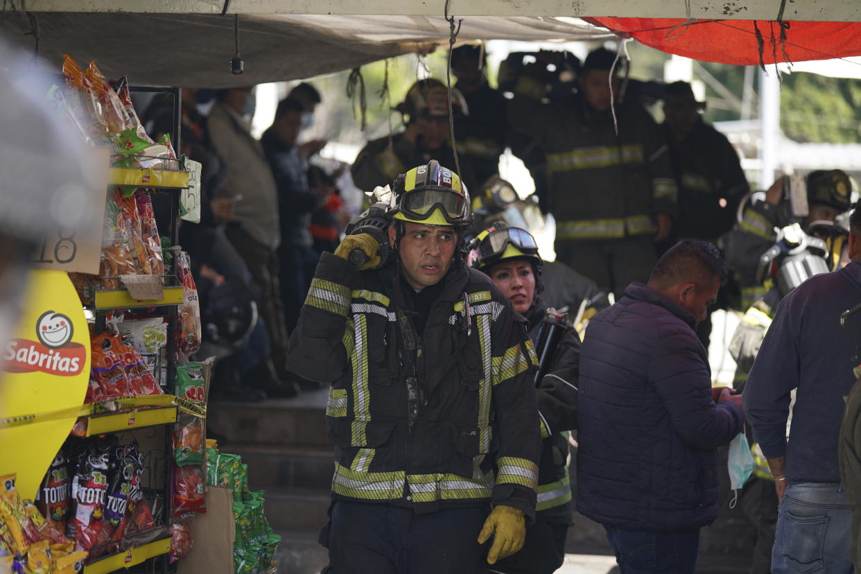Rescue workers exit the Raza station where two subway trains collided, in Mexico City, Saturday, Jan. 7, 2023. Authorities announced at least one person was killed and dozens were injured. (AP Photo/Fernando Llano)