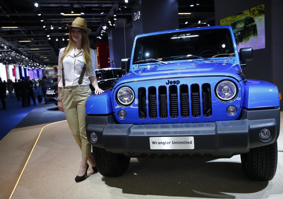 Model poses beside a Jeep Wrangler Unlimited vehicle at Frankfurt Motor Show