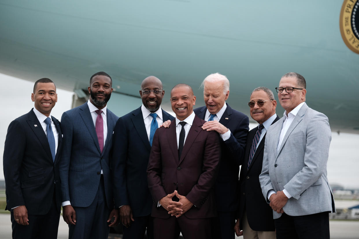 President Joe Biden is welcomed to Atlanta by a delegation of Morehouse College alumni including, from left: Mayor Steven Reed of Montgomery, Ala.; Mayor Randall Woodfin of Birmingham, Ala.; Sen. Raphael Warnock (D-Ga.); Marlon Kimpson, a senior Biden administration trade advisor; Rep. Sanford Bishop (D-Ga.); and John Eaves, a former Fulton County commissioner, at the Hartsfield International Airport, May 18, 2024. (Michael A. McCoy/The New York Times)