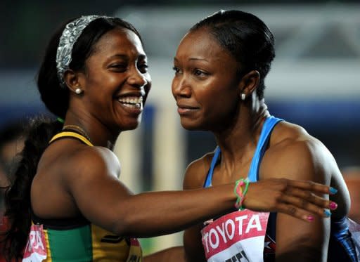 This file photo shows Carmelita Jeter (R) of the US embracing Jamaica's Shelly-Ann Fraser after competing in the women's 100m final at the IAAF World Championships in Daegu, in 2011. Both sprinters are to compete in 100m event at the Olympic Stadium in London, with heats taking place on Friday