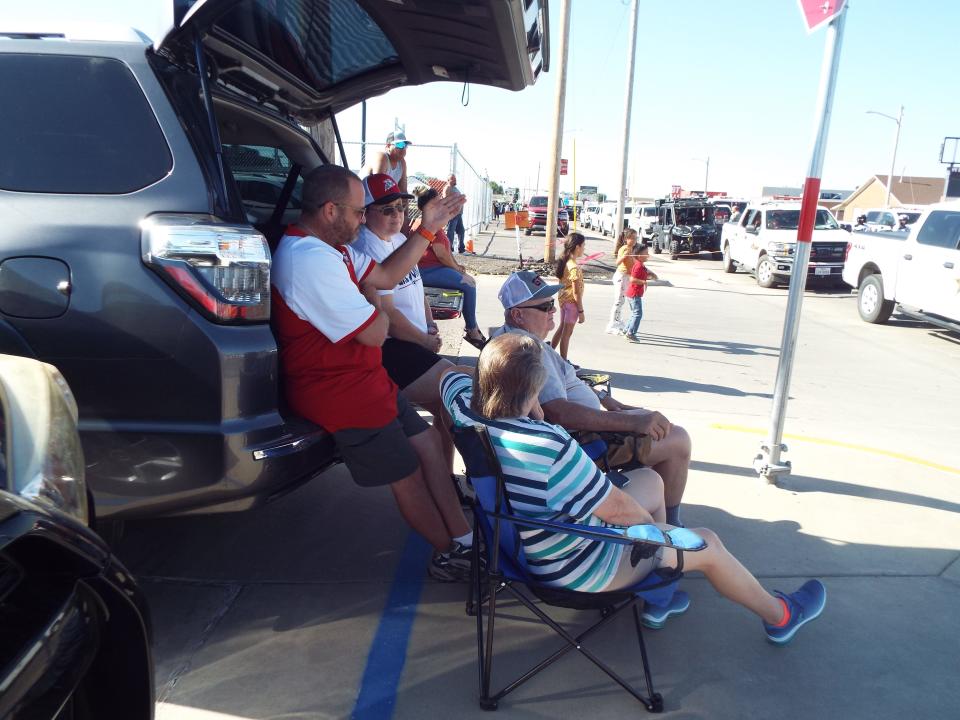 A Perryton family gets comfortable for the Bent but not Broken Parade in Perryton Saturday morning as part of this year's Wheatheart of the Nation celebration.