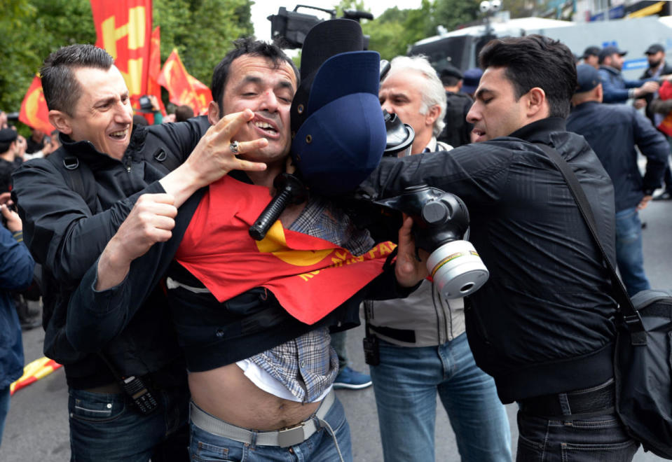 Police detain a man