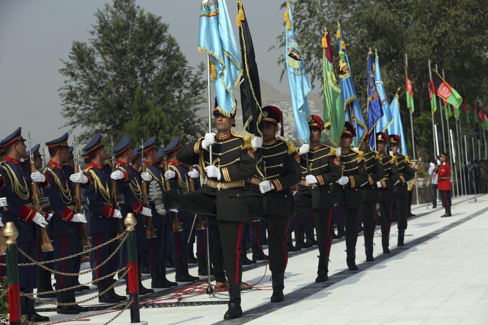 Members of the honor guard stand at attention during the Independence Day celebrations at Defense Ministry in Kabul, Afghanistan, Tuesday, Aug. 18, 2020. Several mortar shells slammed into various part of Kabul on Tuesday morning as Afghans marked their country's Independence Day amid new uncertainties over the start of talks between the Taliban and the Kabul government. (AP Photo/Rahmat Gul)