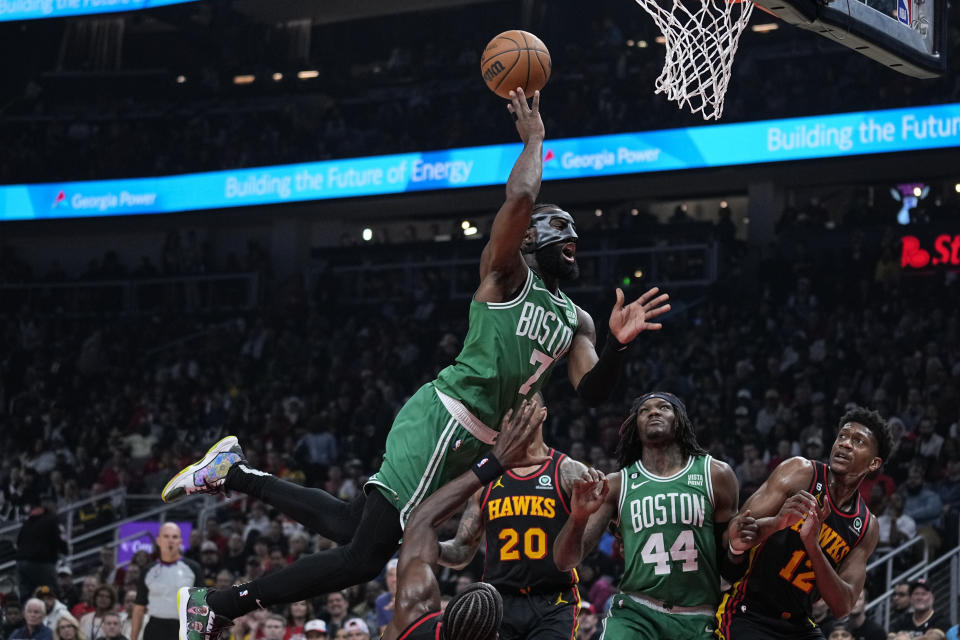 Boston Celtics' Jaylen Brown (7) fouls Atlanta Hawks' Clint Capela (15) while attempting to score during the first half of Game 6 of a first-round NBA basketball playoff series, Thursday, April 27, 2023, in Atlanta. (AP Photo/Brynn Anderson)