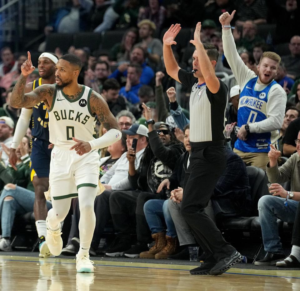 Milwaukee Bucks guard Damian Lillard (0) reacts after hitting a three-pointer that put him fifth on the all-time NBA list for three-point field goals made during the second half of their game Dec. 13, 2023, at Fiserv Forum. The Bucks beat the Indiana Pacers, 140-126.