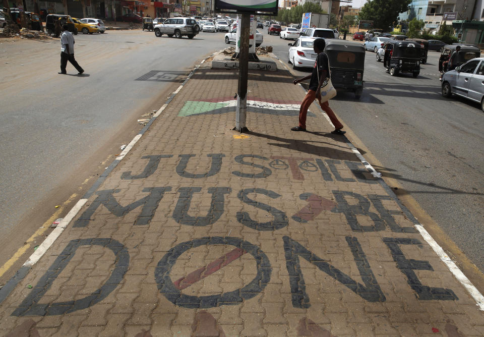 A slogan written by the opposition is painted on a sidewalk in Khartoum, Sudan, Wednesday, June 19, 2019. Sudan's military council is urging protest leaders to resume negotiations on the transition of power, but says talks "should not be preconditioned." (AP Photo/Hussein Malla)