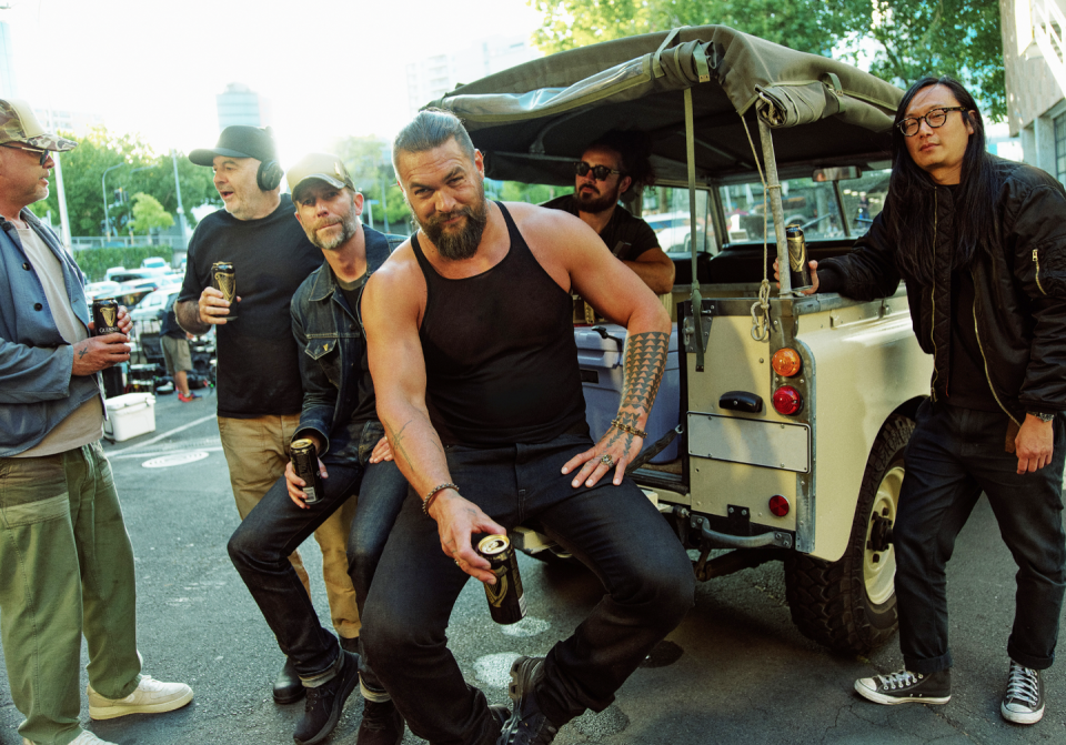 a group of men standing around a truck